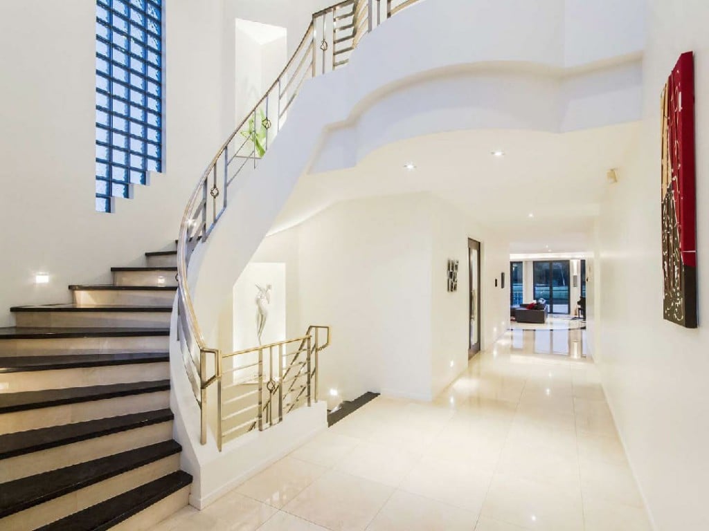 Brass rail staircase spacious interiors in this gold coast home